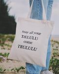 Tote bag with funny quote held by a person at the beach