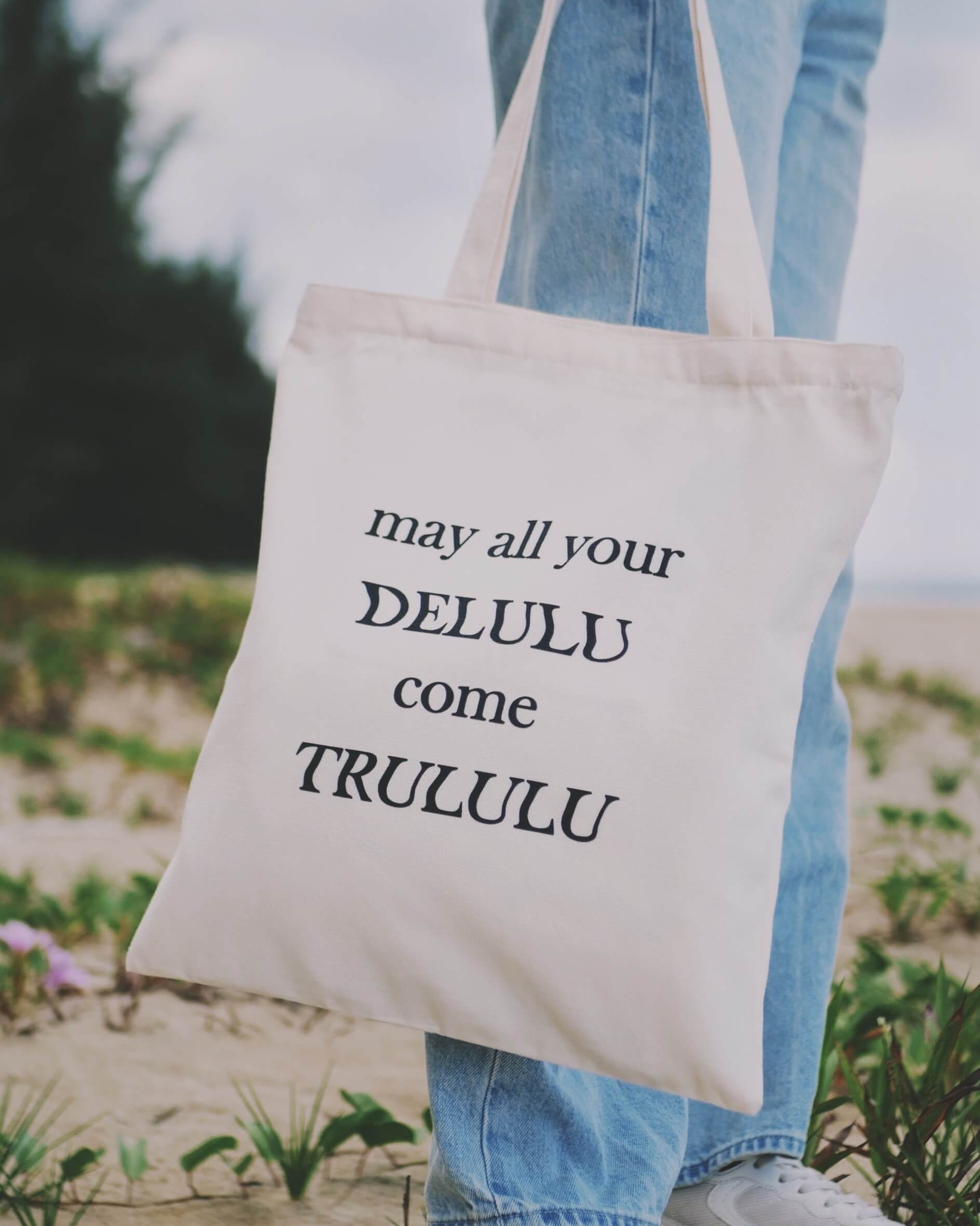 Tote bag with funny quote held by a person at the beach