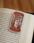 Magnetic bookmark of a ghost in an hourglass design on an open book.