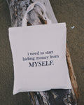 White tote bag with humorous text about "hiding money from myself"
