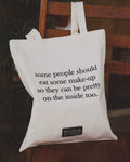 Tote bag with humorous text about fake people on a wooden chair