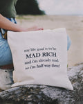 Tote bag with humorous text held by a person at the beach.