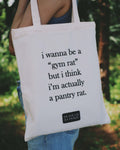 Tote bag with humorous text about bring a gym rat and pantry rat held by a person outdoors