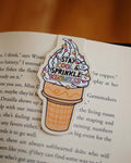 Ice cream cone-shaped magnetic bookmark with 'Stay Cool & Sprinkle Kindness' clipped on a page.