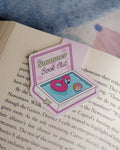 Summer Book Club magnetic bookmark with a pool design clipped on an open book